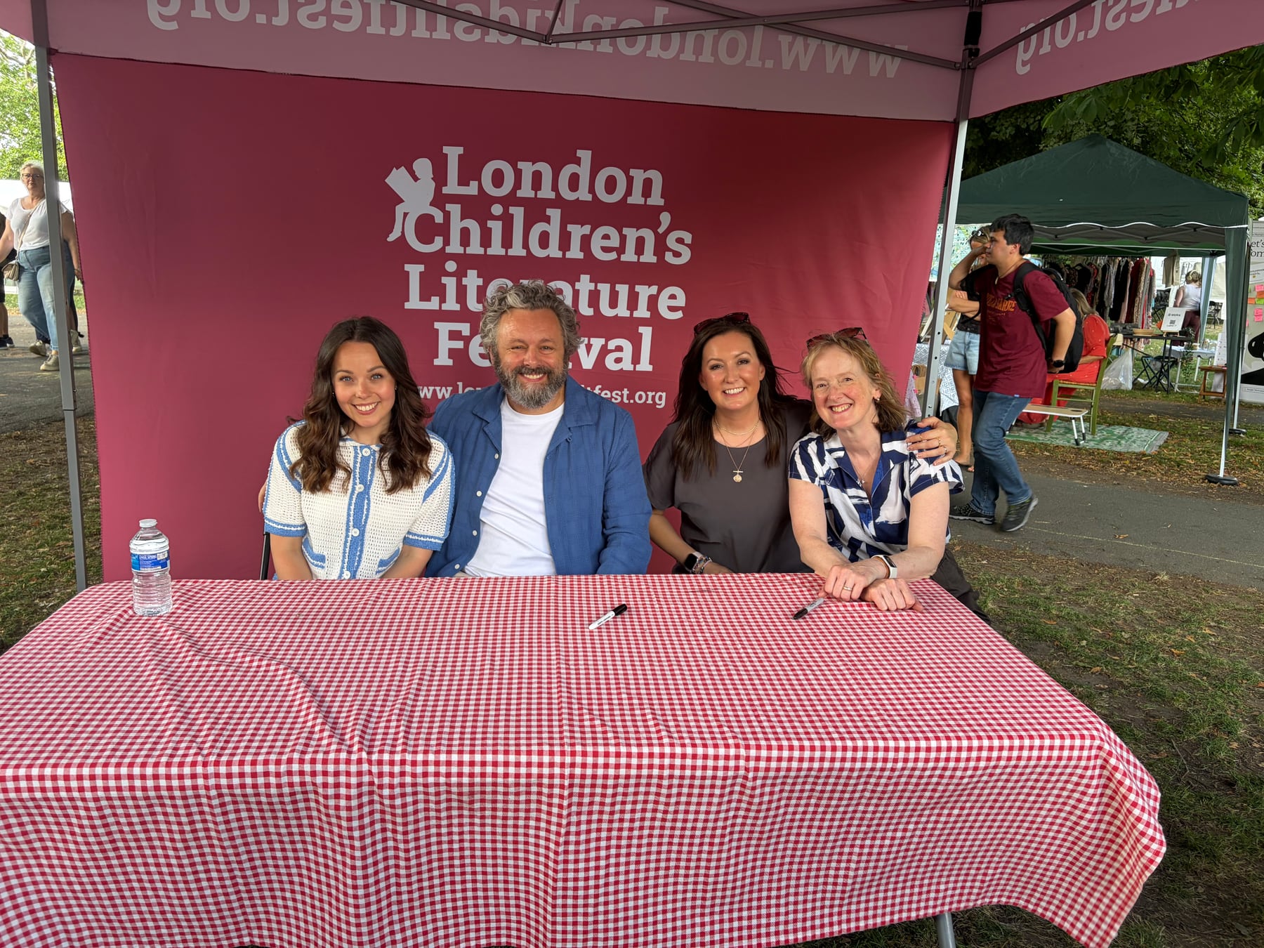 Jess Webb with fellow speakers beneath the London Children's Literature Festival banner